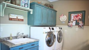 Custom-Built Luxury Home Laundry Room: Utility Sink Counter, Folding Table, Hanging Rack, Wall Mounted Storage Cabinets, Luxury Homes, Indianapolis, Indiana